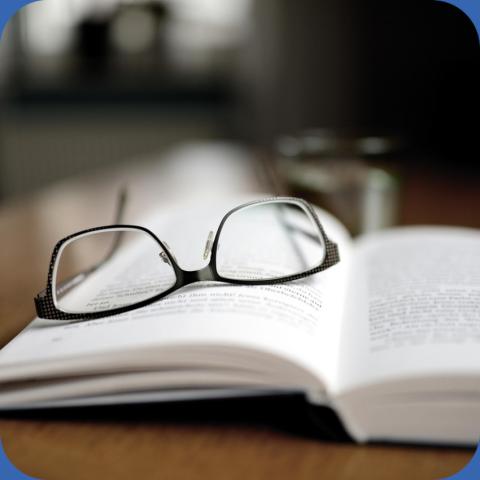 Christian Römmer (IBM and the Holocaust) (image is of glasses resting on an open book